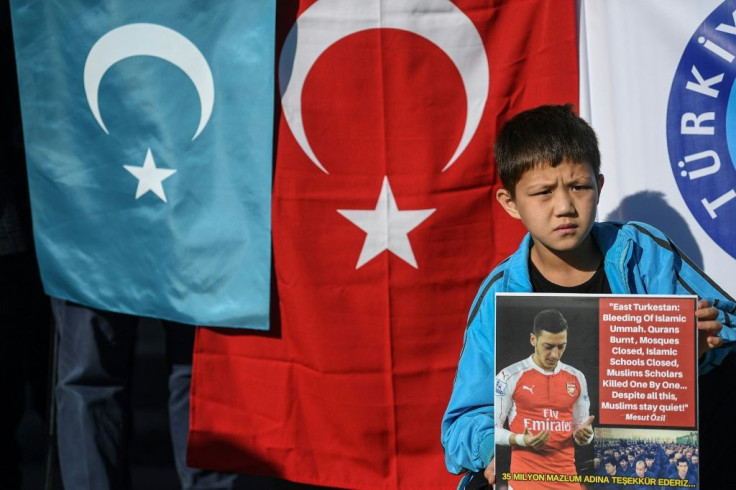 A supporter of China's Muslim Uighur minority holds a placard of Arsenal's Turkish-origin German midfielder Mesut Ozil during a demonstration at Beyazid square in Istanbul