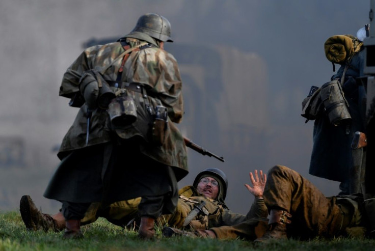 Actors re-enact a scene from the Battle of the Ardennes as part of commemorations marking the 75th anniversary of the WWII battle