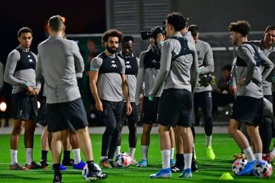 Mohamed Salah (C) and his Liverpool teammates train in Doha on Monday as manager Jurgen Klopp watches on