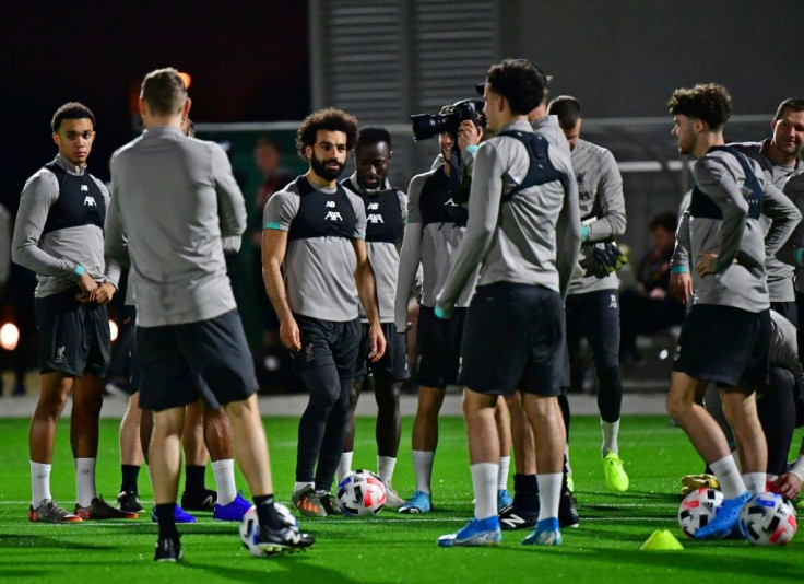 Mohamed Salah (C) and his Liverpool teammates train in Doha on Monday as manager Jurgen Klopp watches on