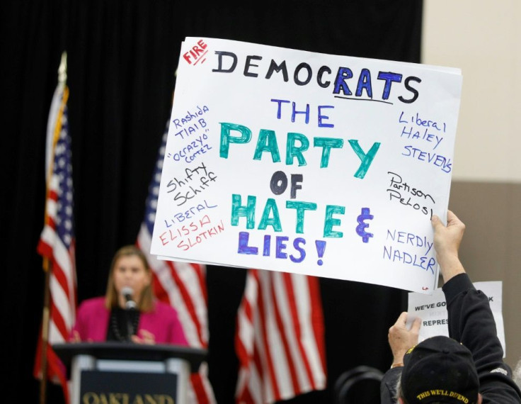 House Democrat Elissa Slotkin (L) faced heckling and protests when she told a town hall in her battleground state of Michigan, after weeks of deliberation, that she would vote to impeach US President Donald Trump