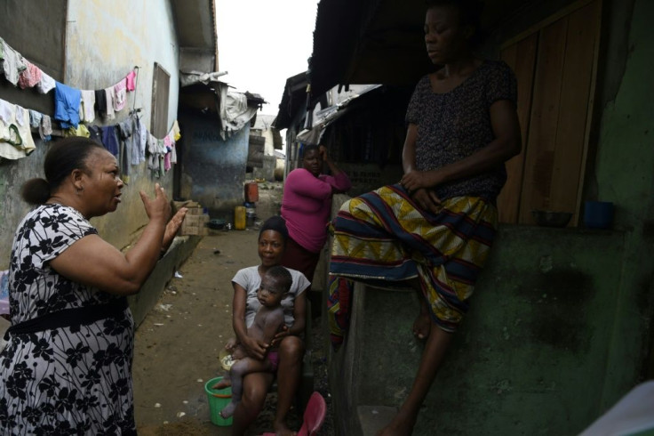 Grassroots message: MSF volunteer Christine Harrison, left, talks to a family about sexual abuse