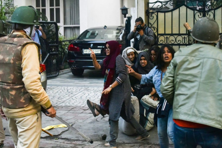 History student Ayesha Renna (red scarf) and three women have become protest symbols after they surrounded a young man to stop him from being beaten by police