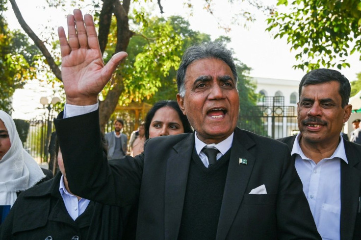 Former military ruler Pervez Musharraf's lawyer Akhtar Shah gestures to the media outside a special court in Islamabad