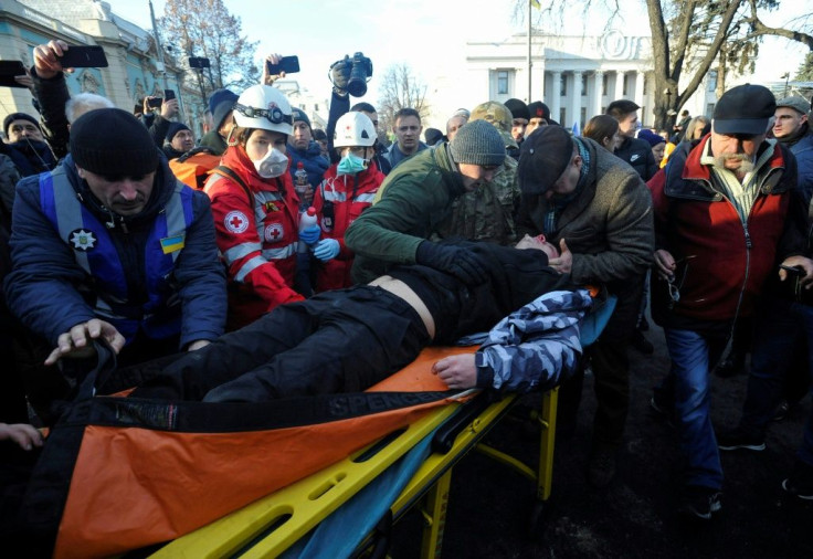 An injured protester receiving aid