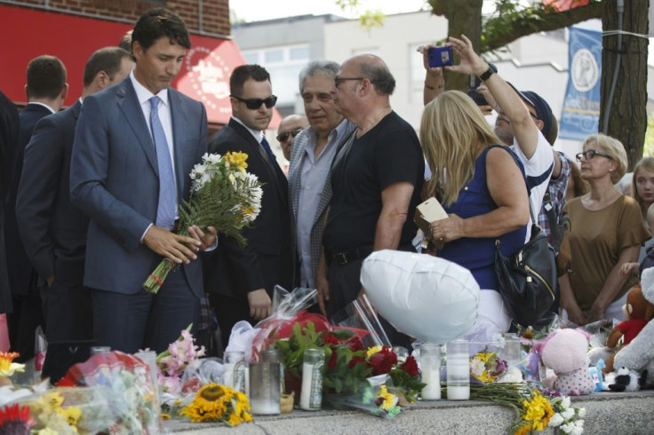 Canadian Prime Minister Justin Trudeau lays flowers at a memorial for  victims of a mass shooting in Toronto July 30, 2018