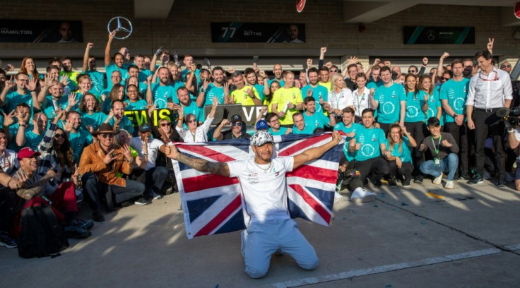 Lewis Hamilton flew the flag with his crew after clinching the Formula 1 title in Texas