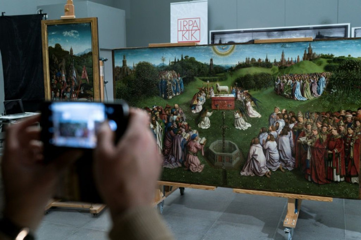 A man takes a photo of the restored original -- which took the artists 12 years of painstaking work -- at Ghent's Museum of Fine Arts