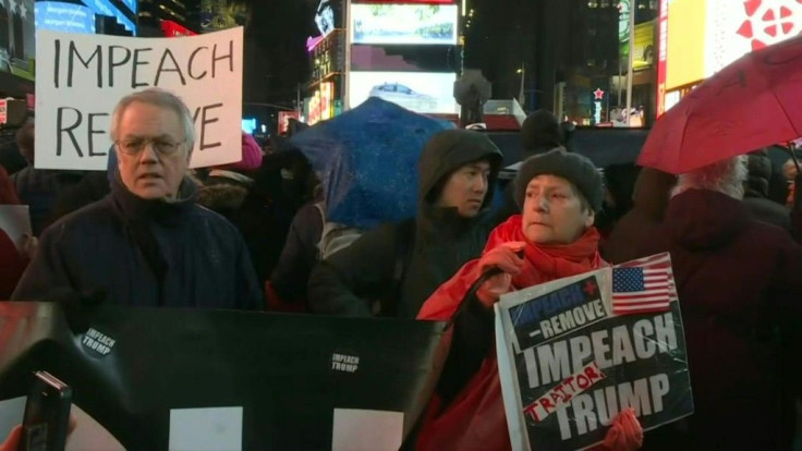 IMAGESHundreds of anti-Trump protesters gather in a rainy Times Square in New York, to chant and demonstrate against the US president the day before US lawmakers will take a historic and highly anticipated vote on impeaching Donald Trump.