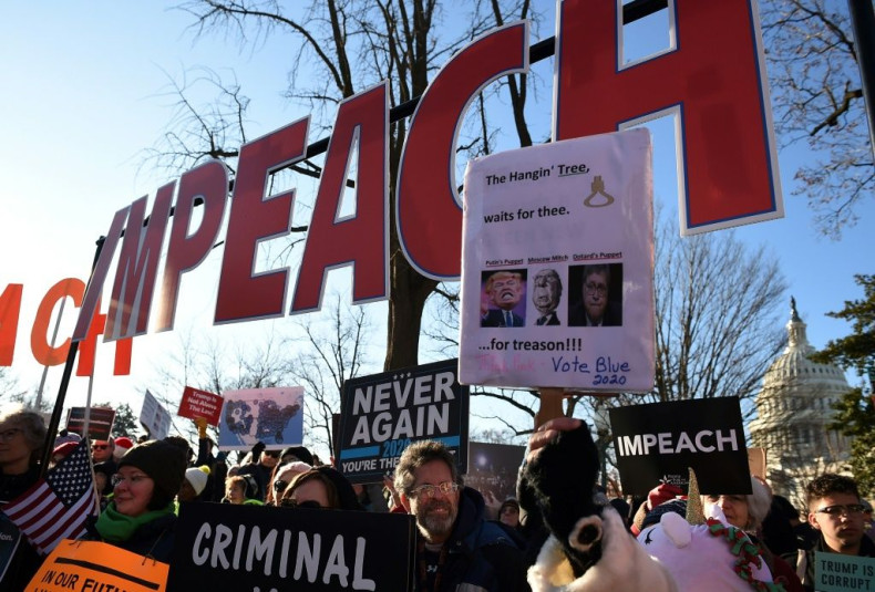 People rally in support of the impeachment of US President Donald Trump in front of the US Capitol, as the House of Representatives prepares for a landmark vote