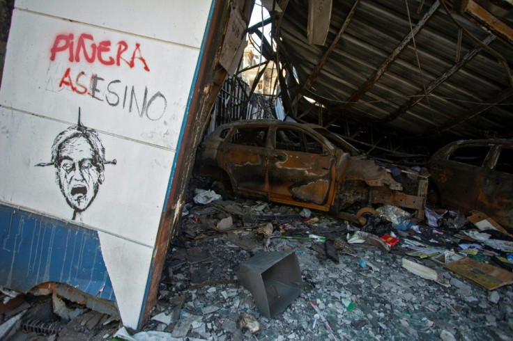 Some areas of Valparaiso have been reduced to rubble -- here, a sign reads "Pinera assassin," referring to Chile's President Sebastian Pinera