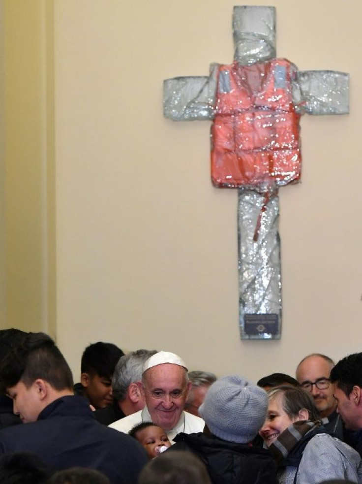 Pope Francis unveiled a resin cross adorned with the life jacket of a migrant who died last year crossing the Mediterranean