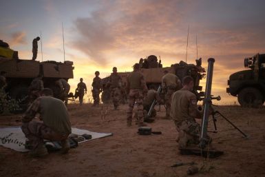 As night draws in, troops draw up their armoured personnel carriers in a square and ready mortars in case of attack