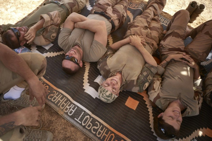 A quick lie-down: Soldiers grab a few moments' respite