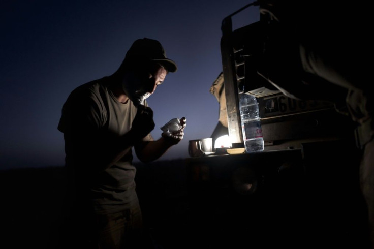 Time for a shave: Troops who are not on guard duty catch up with their rest or their daily chores