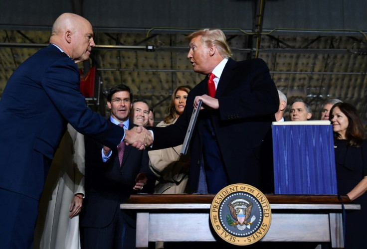 US President Donald Trump (right) shakes hands with Air Force General Jay Raymond, who will lead the newly established Space Force, at Joint Base Andrews, Maryland on December 20, 2019
