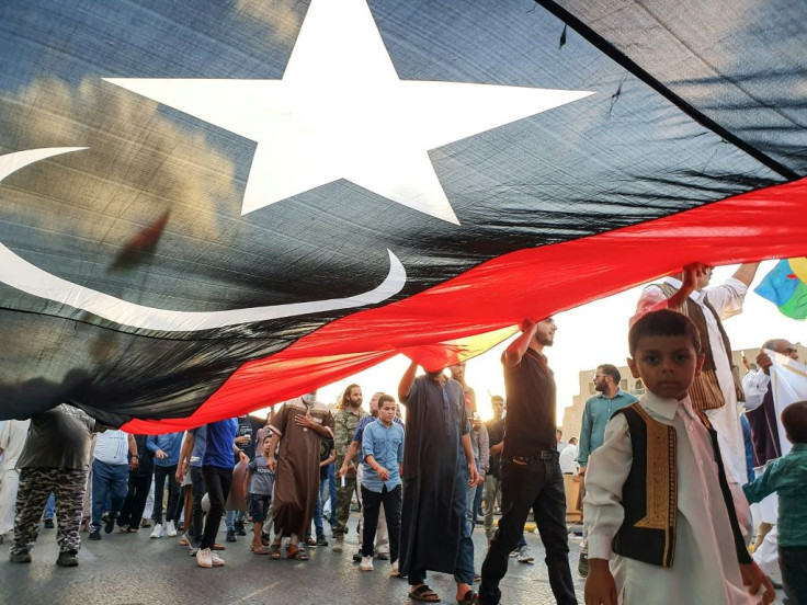 Libyans march with a giant national flag during a rally in support of the Tripoli-based UN-recognised government in September