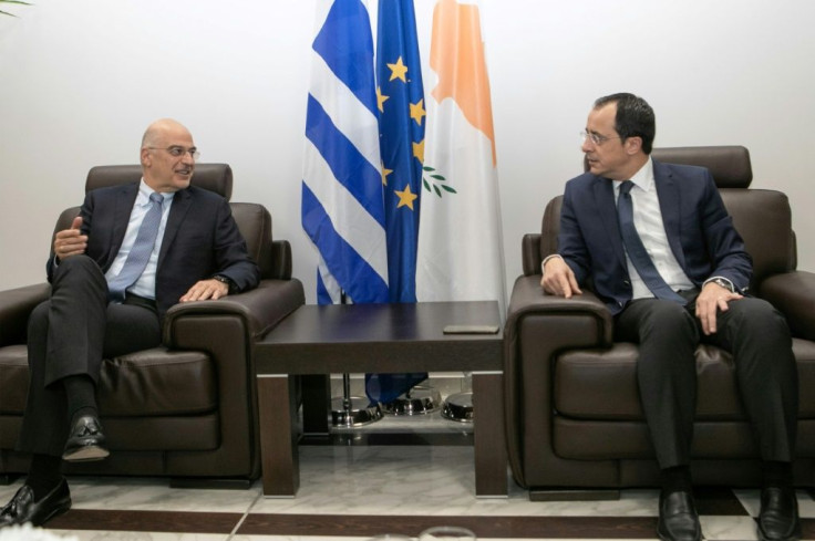 Cypriot Foreign Minister Nikos Christodoulides (R) met with his Greek counterpart Dendias at Larnaca airport near the end of the Greek diplomat's whistle-stop tour