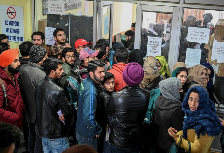 Kashmiri students wait for their turn to use the internet, with only around a dozen kiosks for the region's seven million inhabitants