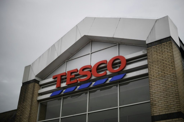 Supermarket giant Tesco said it had stopped production at a factory in China after one of its charity cards was found to contain a cry for help from a prisoner who made it, according to the Sunday Times newspaper