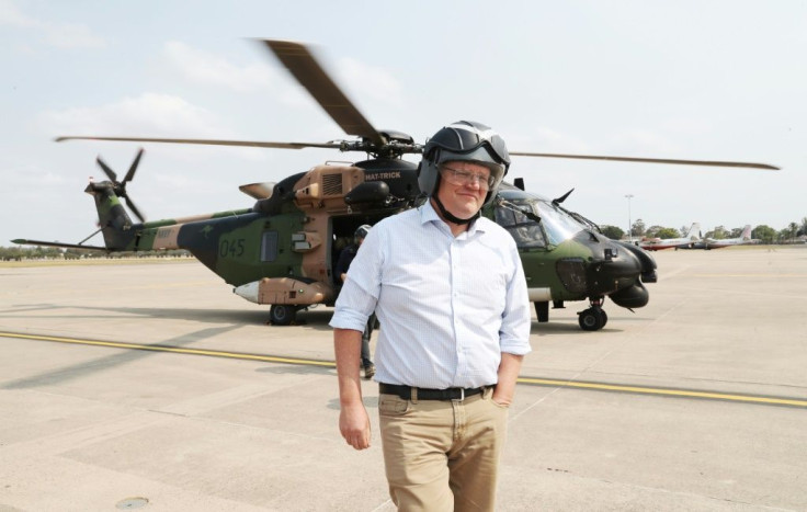 Australian Prime Minister Scott Morrison returns to Mudgee, New South Wales after flying over bushfires in an Australian Defence Force helicopter -- he has defended the country's coal industry in the face of calls for more climate-friendly policy