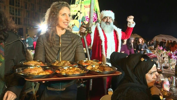 Lebanese activists serve up a Christmas dinner to more than a thousand people next to a "revolutionary" Christmas tree made of protest banners in Beirut's Martyr Square.