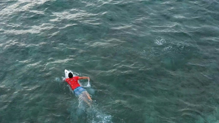 Surfboard tucked under his arm, Dery Setyawan sprints into the crashing waves. It is not just a physical challenge but an emotional one -- most of his family and friends were swept to their deaths when a tsunami hit these shores 15 years ago.