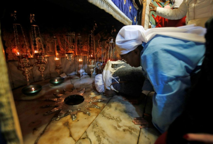A Christian pilgrim kisses the 14 pointed silver star, believed to be the exact spot where Jesus Christ was born, in the Grotto of the Church of the Nativity in Bethlehem