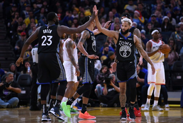 Golden State's Draymond Green (L) and Ky Bowman celebrate on the way to the Warriors' NBA win over the Houston Rockets