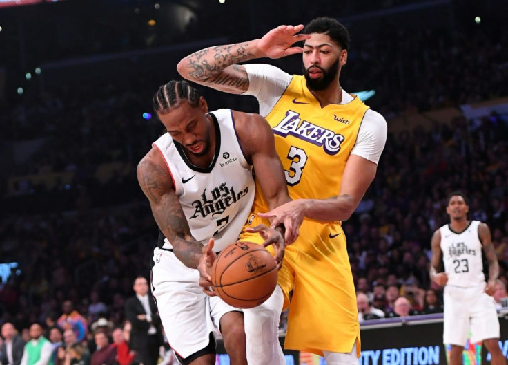 Kawhi Leonard of the Los Angeles Clippers (L) is fouled by the Lakers' Anthony Davis in the Clippers' 111-106 NBA victory over the Lakers