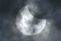 The moon moves in front of the sun during the start of the rare "ring of fire" solar eclipse in Jakarta