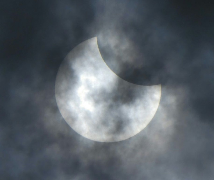 The moon moves in front of the sun during the start of the rare "ring of fire" solar eclipse in Jakarta
