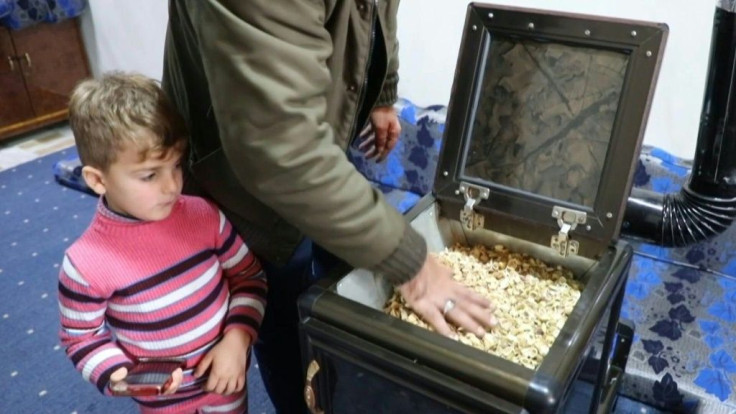 Syrians in violence-plagued Idlib bracing for a harsh winter and suffering from an acute fuel crisis have turned to heating alternatives like burning pistachio shells to keep warm.