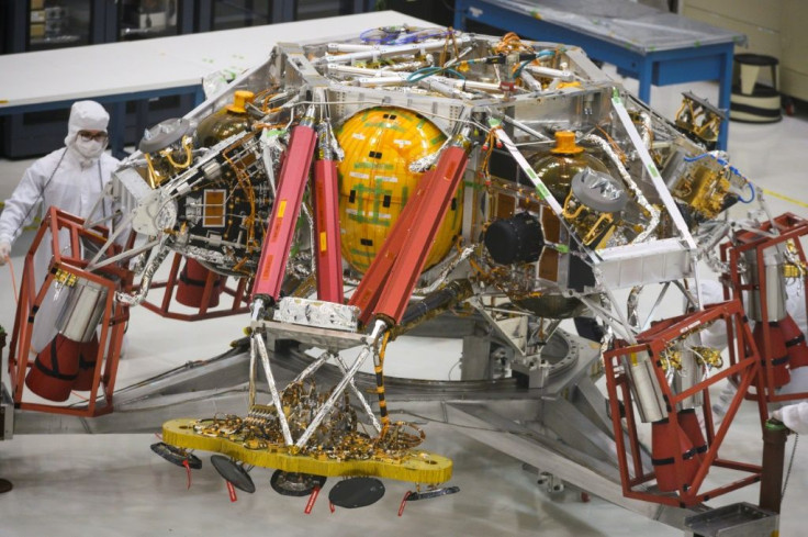 NASA engineers and technicians reposition the Mars 2020 spacecraft descent stage equipment, which will be used to land the rover on the Red Planet