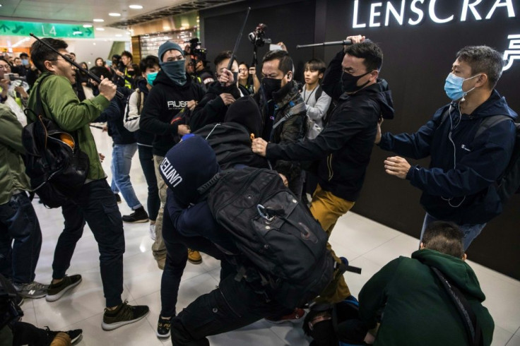 Plainclothes police, with batons, clash with pro-democracy protesters at a Hong Kong shopping mall