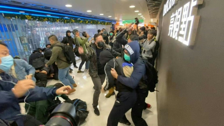 IMAGES Plainclothes police officers baton-charge protesters in a Hong Kong shopping mall. Major shopping centres have become regular protest venues with demonstrators attempting to disrupt the economy in their push for greater democratic freedoms and poli