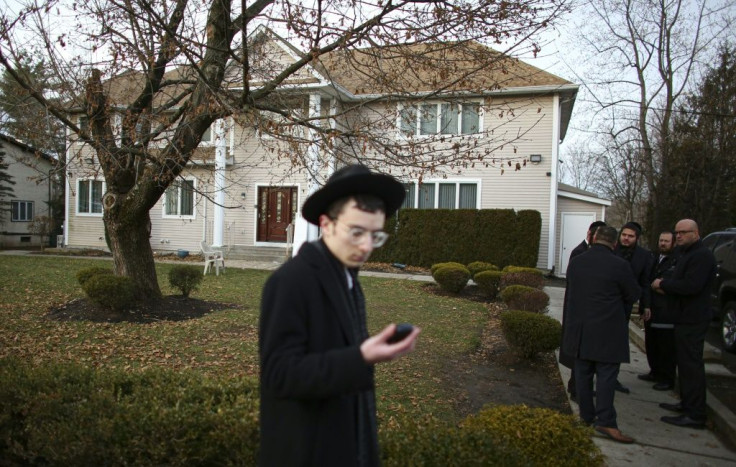 A man stands outside the home of rabbi in Monsey, in New York on December 29, 2019 where a machete attack that took place