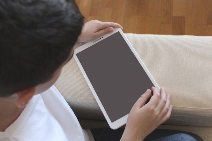 Child Playing With Tablet
