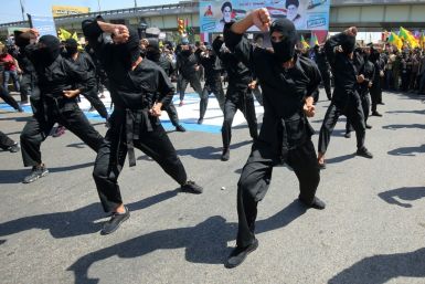 Iraqi Shiite fighters from the Iran-backed Hezbollah brigades take part in a military parade to mark the pro-Palestinian Al-Quds (Jerusalem) Day in Baghdad in May this year