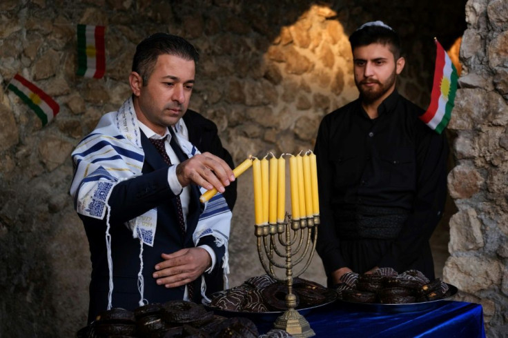 Members of the Jewish community in Iraqi Kurdistan light a menorah for Hanukkah in the town of Al-Qosh