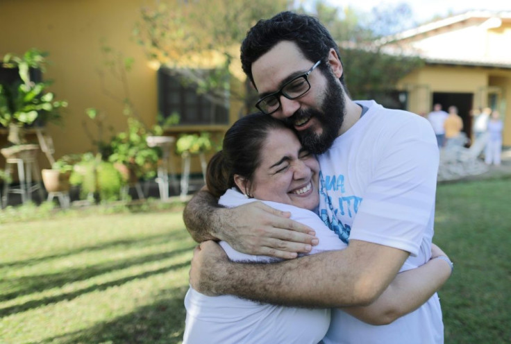 Jesus Tefel (R) embraces a friend after been released from "El Chipote" prison