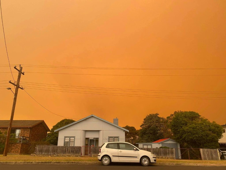 Distant bushfires light up the skies in the coastal town of Bermagui in New South Wales state