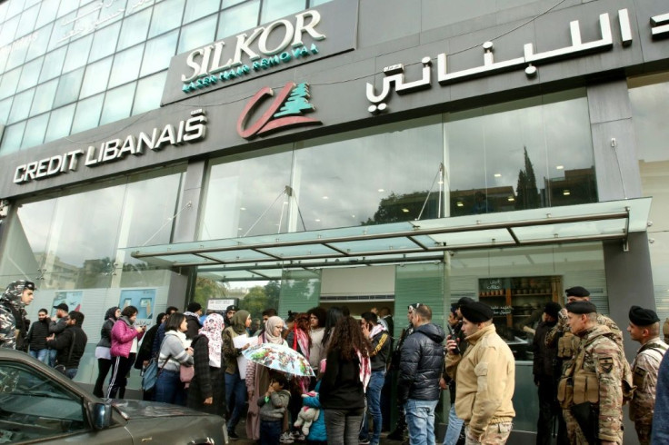 Lebanese protesters rally outside a bank against nationwide restrictions on dollar withdrawals and transfers abroad