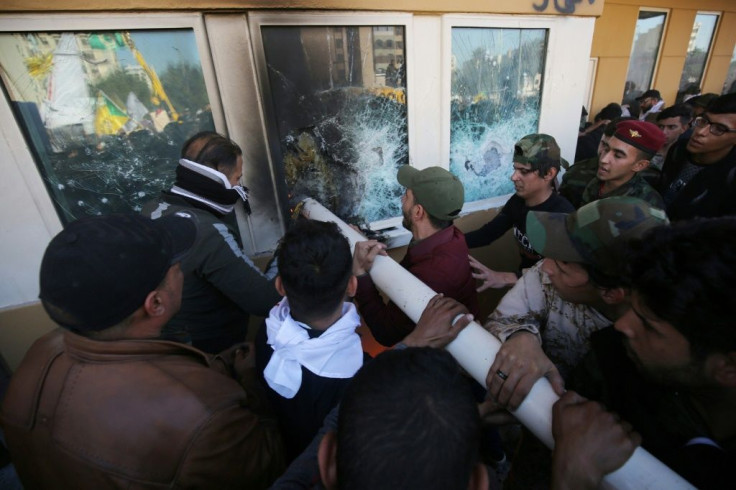 Iraqi protesters attacking the US embassy in Baghdad
