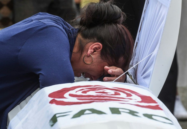 A relative mourns over the coffin of former FARC guerrilla Manuel Antonio Gonzalez on December 17, 2019, in Medellin, near the end of the deadliest year for the former Colombian rebels since a 2016 peace deal