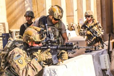 American soldiers take positions around the United States embassy in Baghdad, Iraq after supporters and members of the Hashed al-Shaabi military network breached the outer wall of the mission