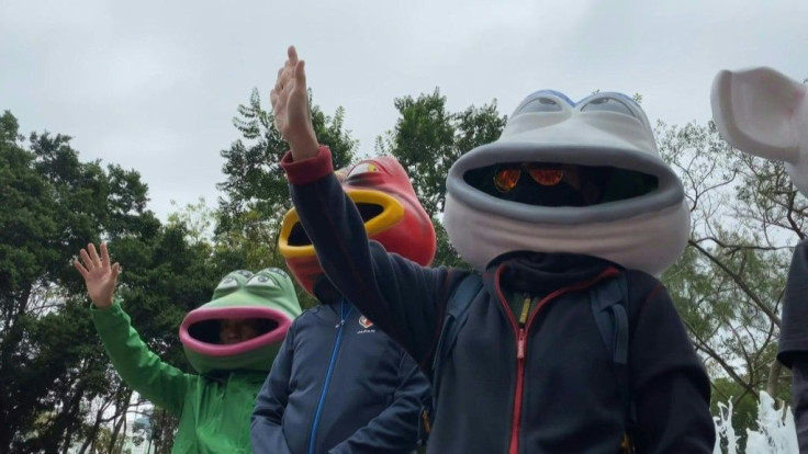 IMAGESPeople sporting various Pepe the Frog masks get ready to take part in a huge pro-democracy march in Hong Kong. The city has been battered by more than six months of unrest with millions marching, as well as confrontations in which police have fired 