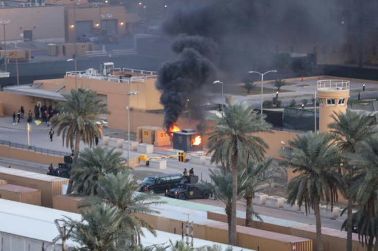 A sentry box burns at an entrance to the United States embassy in the Iraqi capital Baghdad