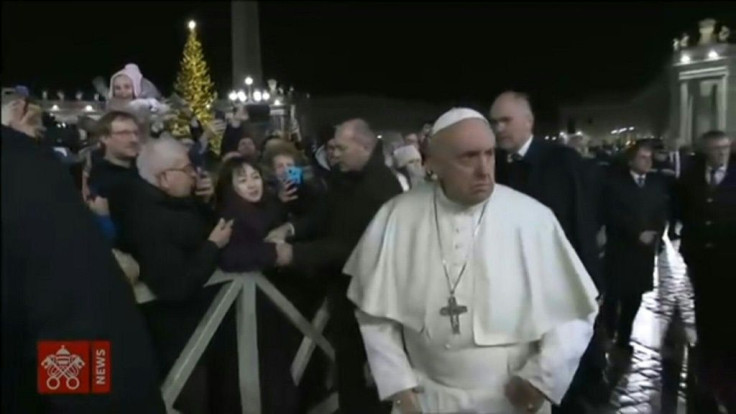 Pope Francis angrily slaps away a woman's hand when she grabs it during his walk around the Vatican's St Peter's Square.