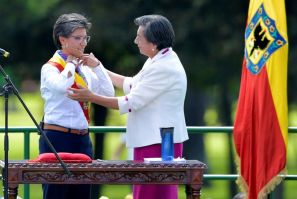 Bogota's incoming Mayor Claudia Lopez (L) is presented with the mayoral sash during her inauguration